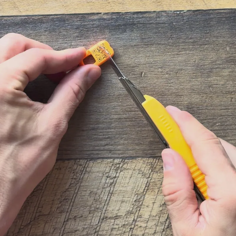 Scratching a Premium QR Tag with a blade